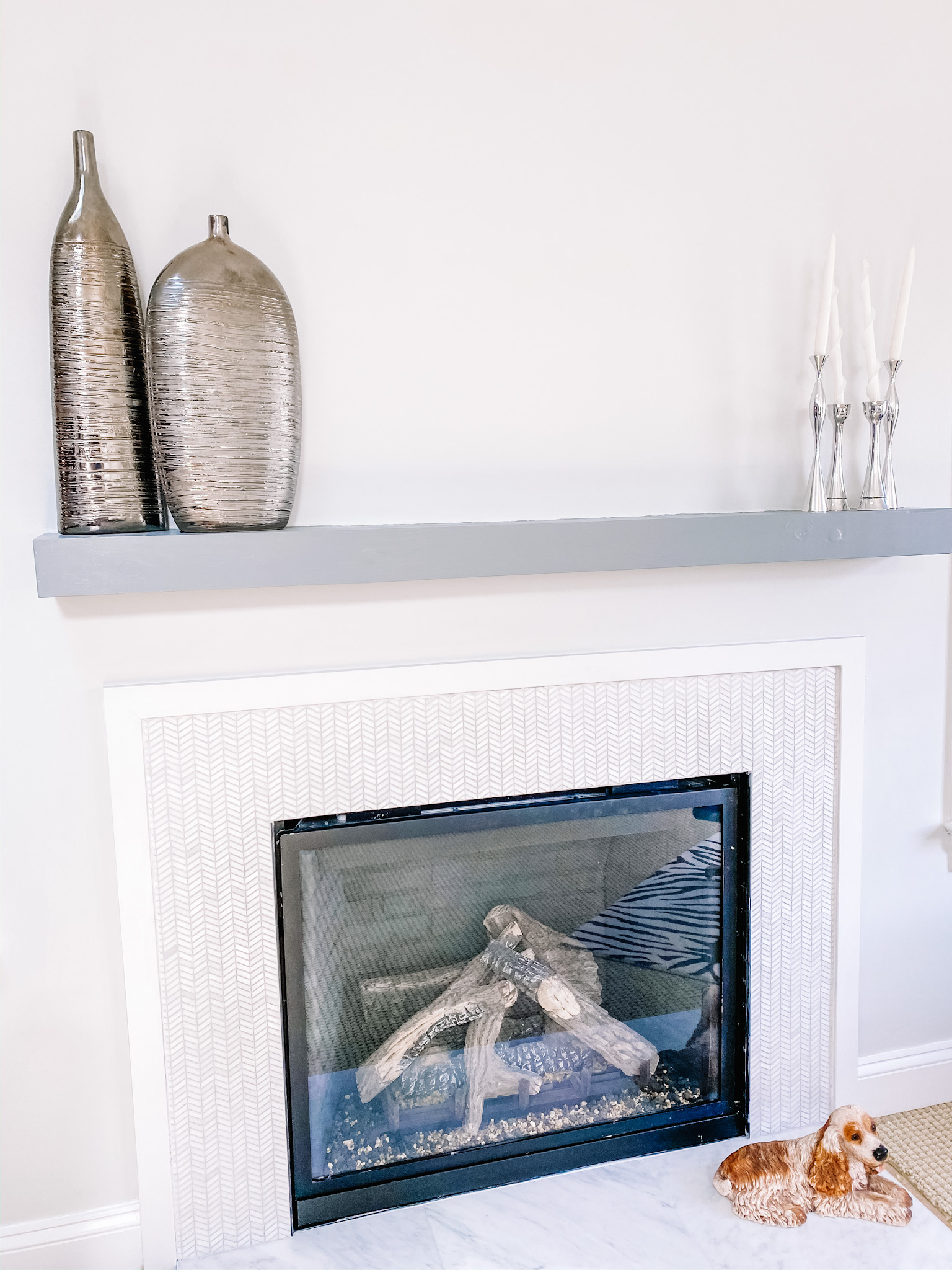 An modern chevron marble fireplace with floating mantle