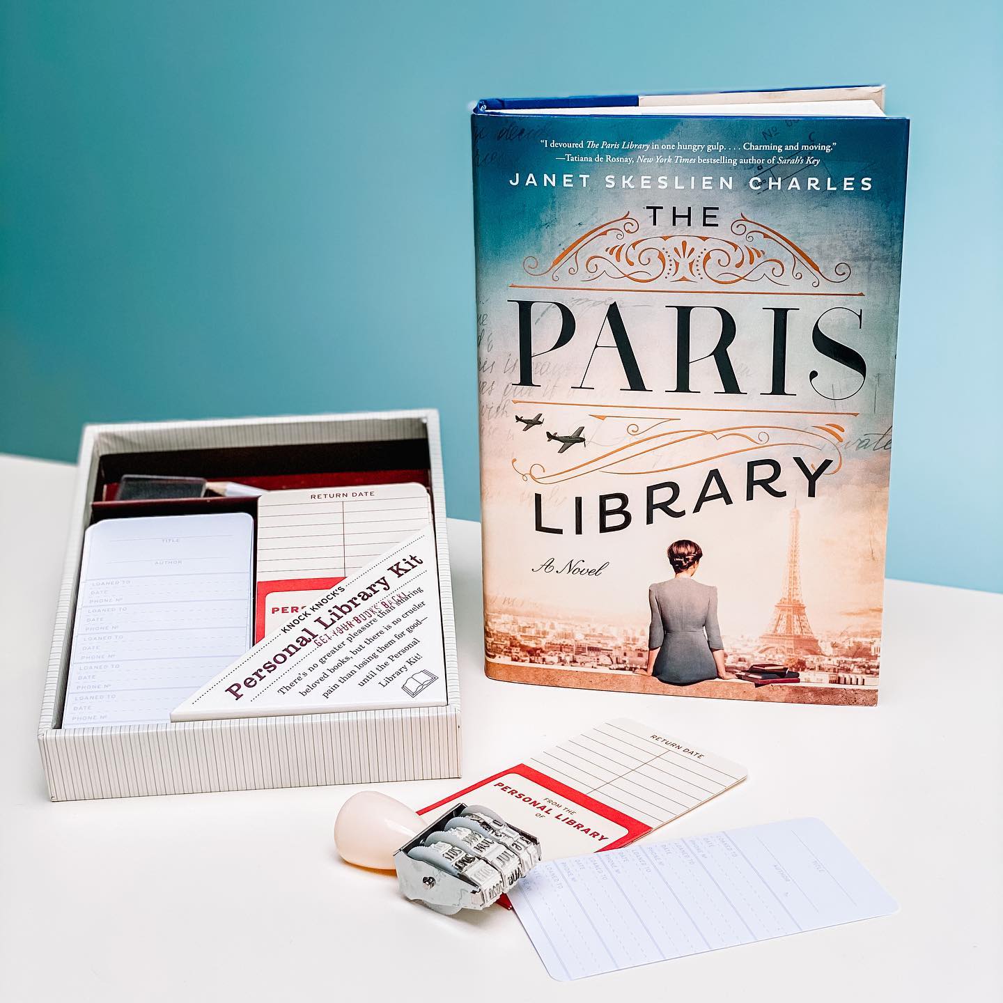 Best Gifts For Book Lovers 2 Personal library kit with stamp and due date cards next to The Paris Library